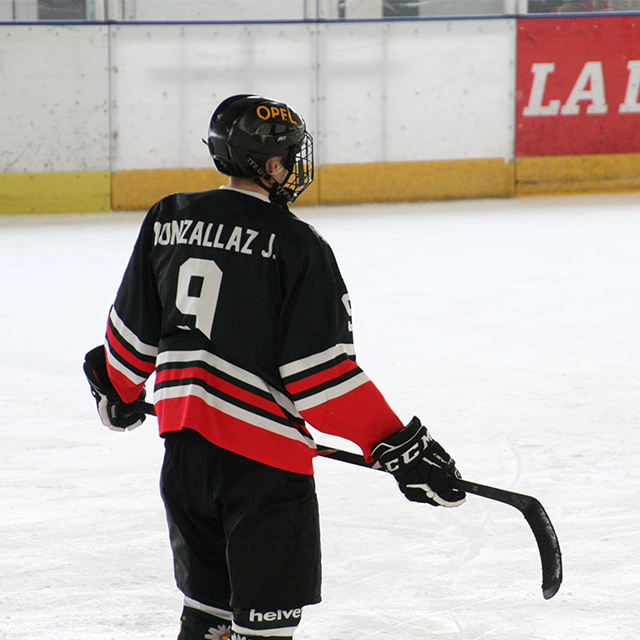 Joé standing on an ice hockey field